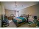 Relaxing bedroom features a decorative ceiling light, a comfy bed, and a workspace at 15733 Fishhawk Falls Dr, Lithia, FL 33547
