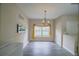 Inviting dining space with laminate flooring, a modern chandelier, and large windows for natural light at 15733 Fishhawk Falls Dr, Lithia, FL 33547