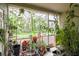 Enclosed patio featuring lush greenery and a view of the backyard and foliage at 15733 Fishhawk Falls Dr, Lithia, FL 33547