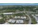 Panoramic aerial view of a residential community surrounded by lush greenery and blue skies at 1805 Vera Pl # 2, Sarasota, FL 34235