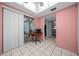 Hallway with tile flooring, painted in a pink shade, offering a glimpse into connecting rooms at 1805 Vera Pl # 2, Sarasota, FL 34235