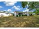 Exterior of single-story home featuring lush bushes and a well-kept lawn on a sunny day at 1805 Vera Pl # 2, Sarasota, FL 34235