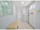 Bright hallway with tiled floors, front door, and a decorative mirror at 1805 Vera Pl # 2, Sarasota, FL 34235