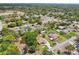 An aerial view showcases neighborhood homes nestled among lush greenery and mature trees at 2016 Alameda Dr, Spring Hill, FL 34609