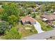 Aerial view of a charming single-story home featuring a manicured lawn, a two car garage, and mature landscaping at 2016 Alameda Dr, Spring Hill, FL 34609