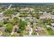 An aerial view of the home surrounded by mature trees, showcasing the neighborhood at 2016 Alameda Dr, Spring Hill, FL 34609