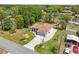 Aerial view of a charming single-story home featuring a manicured lawn, a two car garage, and mature landscaping at 2016 Alameda Dr, Spring Hill, FL 34609