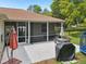The outdoor patio has access to a spacious backyard with outdoor kitchen, grill, trampoline and mature trees at 2016 Alameda Dr, Spring Hill, FL 34609