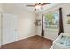 Bedroom/Bedroom features wood-look floors, a ceiling fan, a window with natural light, and minimal decor at 2016 Alameda Dr, Spring Hill, FL 34609