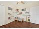 bedroom with wood-look flooring, ceiling fan, and car-themed decorations; closet to the left at 2016 Alameda Dr, Spring Hill, FL 34609
