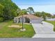 Charming single-story home featuring a manicured lawn, a two car garage, and decorative landscape beds at 2016 Alameda Dr, Spring Hill, FL 34609
