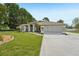 Charming single-story home featuring a well-manicured lawn and an inviting front entrance with beautiful landscaping at 2016 Alameda Dr, Spring Hill, FL 34609