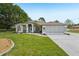 Charming single-story home featuring a well-manicured lawn and an inviting front entrance with beautiful landscaping at 2016 Alameda Dr, Spring Hill, FL 34609