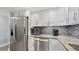 Kitchen featuring stainless steel appliances, sleek countertops, and white cabinets for storage at 2042 Australia W Way # 12, Clearwater, FL 33763