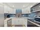 Modern kitchen with stainless steel appliances, sleek countertops, and a stylish tile backsplash at 2042 Australia W Way # 12, Clearwater, FL 33763