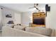 Well-lit living room features a ceiling fan, entertainment center, and couch at 2042 Australia W Way # 12, Clearwater, FL 33763