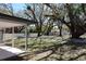 A spacious backyard features mature trees, a picnic table, and a newly built fence at 2105 Curry Rd, Lutz, FL 33549