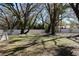 The newly fenced backyard features mature trees offering a peaceful, shaded space at 2105 Curry Rd, Lutz, FL 33549