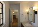 Bathroom showing updated fixtures and a view through to the living room at 2105 Curry Rd, Lutz, FL 33549