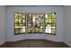 A close-up of a large bay window, showcasing a lush green outdoor view and modern black trim at 2105 Curry Rd, Lutz, FL 33549