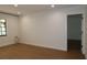 A bright bedroom with hardwood floors and a window letting in natural light at 2105 Curry Rd, Lutz, FL 33549