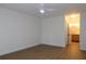 Spacious bedroom featuring a ceiling fan, hardwood floors, and an attached bathroom at 2105 Curry Rd, Lutz, FL 33549