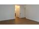 A bright bedroom with hardwood floors, white walls, and access to a closet at 2105 Curry Rd, Lutz, FL 33549