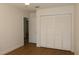 Clean bedroom showcasing a closet with louvered doors and a doorway leading to another room at 2105 Curry Rd, Lutz, FL 33549