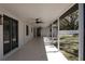 A spacious covered patio with ceiling fans overlooks the backyard and landscaping at 2105 Curry Rd, Lutz, FL 33549