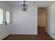 Entryway featuring glass paneled double doors and a modern black light fixture at 2105 Curry Rd, Lutz, FL 33549