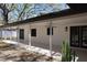 Exterior view of home featuring a covered patio with modern light fixtures and french doors at 2105 Curry Rd, Lutz, FL 33549