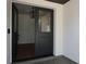 Modern front doors open to an inviting foyer, with decorative black hanging light fixture at 2105 Curry Rd, Lutz, FL 33549