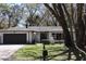 Beautiful single-story home with mature landscaping, well-maintained lawn, and a two-car garage at 2105 Curry Rd, Lutz, FL 33549