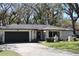 Charming single-story home with a well-manicured front lawn and an attached two-car garage at 2105 Curry Rd, Lutz, FL 33549