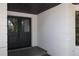 The front of the home has a decorative double door entry with adjacent modern white exterior walls at 2105 Curry Rd, Lutz, FL 33549