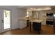 Bright kitchen featuring white cabinetry, stainless steel appliances, and a center island with a light countertop at 2105 Curry Rd, Lutz, FL 33549