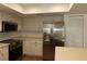 Bright kitchen featuring white cabinets, stainless steel appliances, and ample counter space at 2105 Curry Rd, Lutz, FL 33549