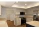 Bright kitchen featuring white cabinets, stainless steel appliances, and a skylight at 2105 Curry Rd, Lutz, FL 33549