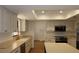 Bright kitchen featuring white cabinets, stainless steel appliances, an island, and a skylight at 2105 Curry Rd, Lutz, FL 33549