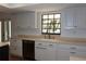 Bright kitchen featuring white cabinets, stainless steel appliances, and a stainless steel faucet at 2105 Curry Rd, Lutz, FL 33549