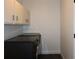 Laundry room with washer, dryer, and overhead storage at 2105 Curry Rd, Lutz, FL 33549