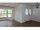Open living space featuring hardwood floors, a modern light fixture and a large bay window at 2105 Curry Rd, Lutz, FL 33549