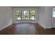 Bright living room featuring hardwood floors, a large bay window and white walls at 2105 Curry Rd, Lutz, FL 33549