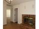 Cozy living room with brick fireplace and hardwood flooring at 2105 Curry Rd, Lutz, FL 33549