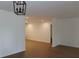 Living room area with freshly painted walls, wood floors, and a large window that brings in natural light at 2105 Curry Rd, Lutz, FL 33549