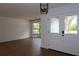 Freshly painted walls and wood floors with a view into the entryway, bringing in natural light at 2105 Curry Rd, Lutz, FL 33549