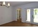 Inviting living room with new flooring and a bright view of the outdoors through double doors at 2105 Curry Rd, Lutz, FL 33549