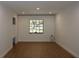 Bright living room featuring hardwood floors and a window with a picturesque outdoor view at 2105 Curry Rd, Lutz, FL 33549