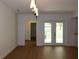 Inviting living room with new flooring and a bright view of the outdoors through double doors at 2105 Curry Rd, Lutz, FL 33549