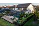 Aerial view of a screened-in pool, spacious patio, lush landscaping, and fenced yard at 21867 Amelia Rose Way, Land O Lakes, FL 34637